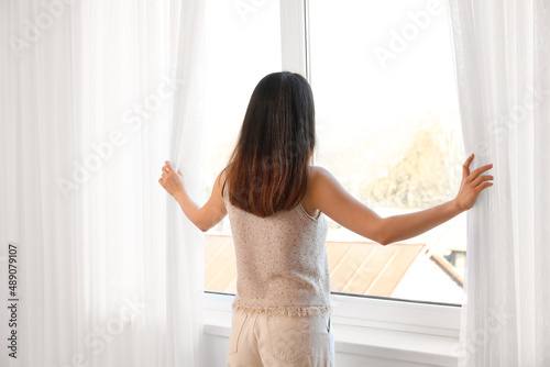 Pretty young Asian woman op...