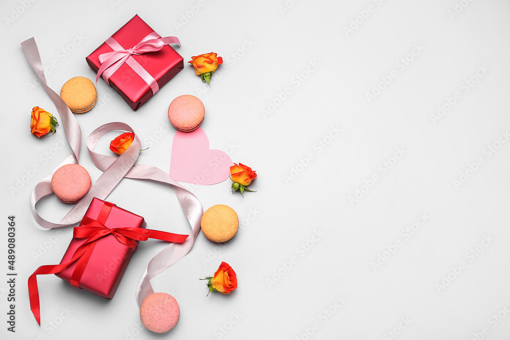 Composition with gifts for International Women's Day celebration, sweet macaroons and rose flowers on white background Composition with gifts for International Women's Day celebration, sweet macaroons and rose flowers on white background