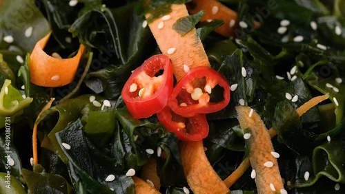 Wakame Seaweed salad with carrots, sesame seeds and sauce. Rotating video