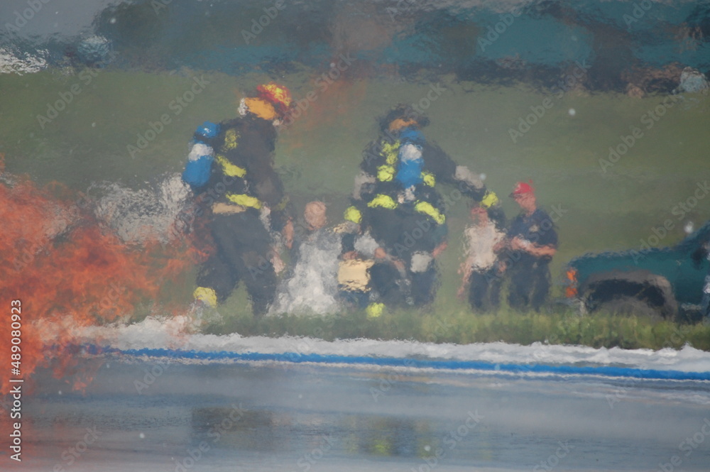 Fototapeta premium two firefighters rescuing victim in training fire