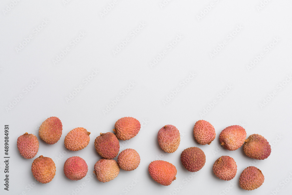 Lychee fruit on color background. Top view, flat lay