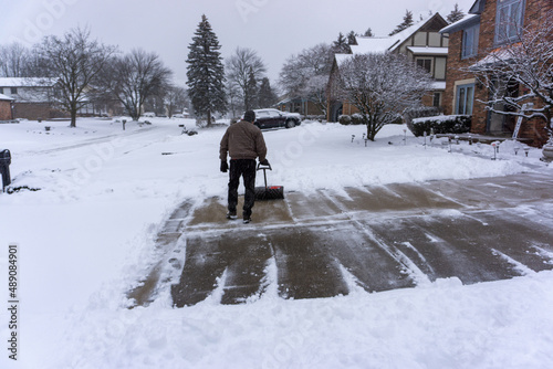 Man clearing driveway in midwest winter