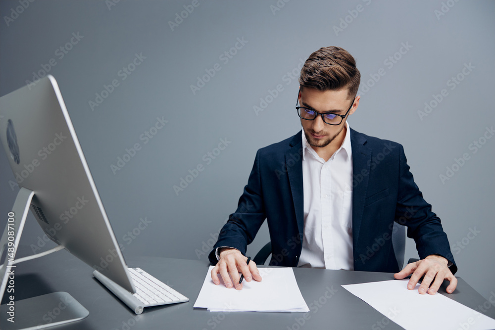 businessmen in glasses with documents on the table Gray background businessmen in glasses with documents on the table Gray background