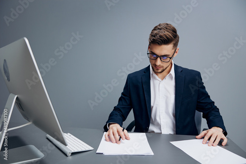 businessmen in glasses with documents on the table Gray background