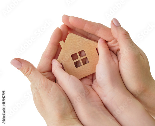 in female and children's hands a small model of the house. Concept - family home, adoption of children, mortgage, home insurance, international family day, foster family. Isolated on white, top view.