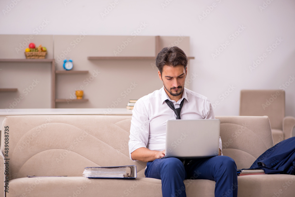 Young male employee working from home during pandemic Young male employee working from home during pandemic