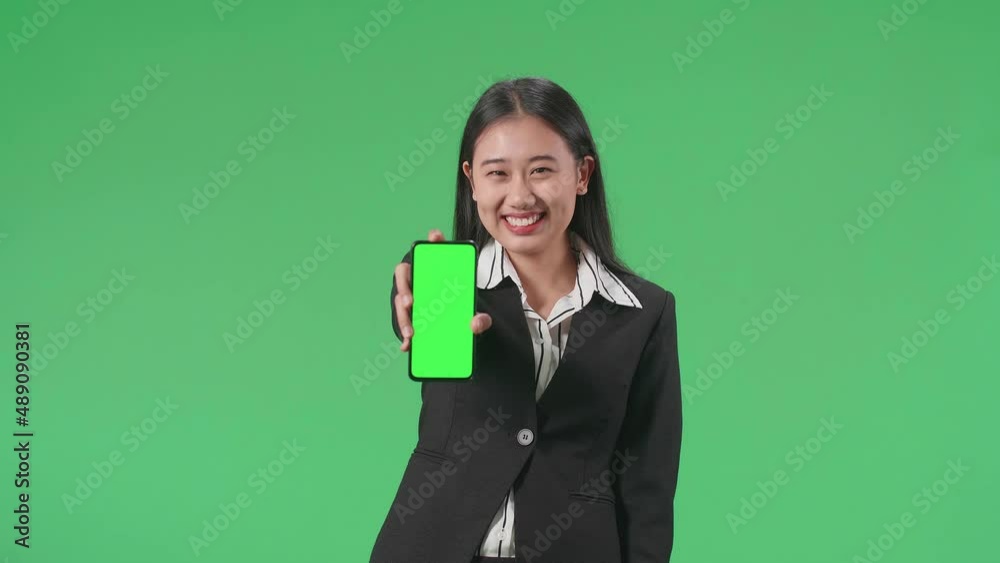 An Asian Business Woman With A Smile Showing Green Screen Mobile Phone And Thumbs Up Gesture While Standing In Front Of Green Screen
An Asian Business Woman With A Smile Showing Green Screen Mobile Phone And Thumbs Up Gesture While Standing In Front Of Green Screen