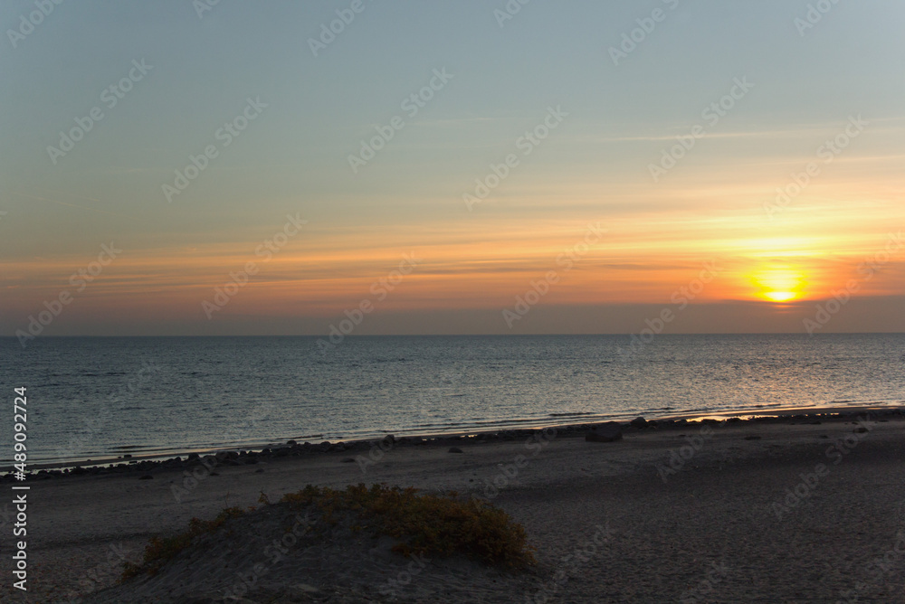 In autumn, during sunset, the clouds partially covered the sun