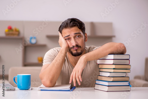 Young male student studying at home during pandemic