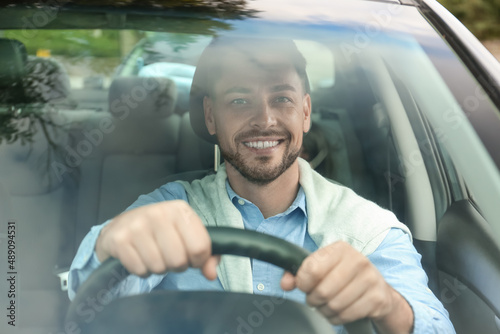 Handsome businessman drivin...
