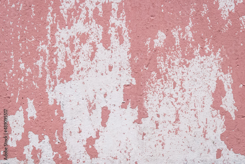 Red peeling paint abstract color pattern design worn weathered white wall surface texture background © Andrey
