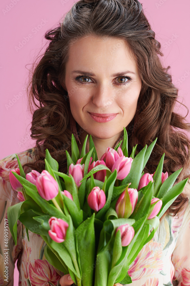Portrait of happy woman with long wavy brunette hair on pink Portrait of happy woman with long wavy brunette hair on pink