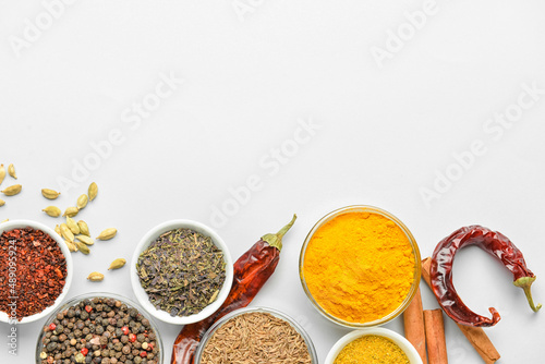Fototapeta Naklejka Na Ścianę i Meble -  Bowls with aromatic spices on white background