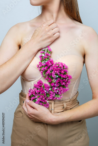 Beautiful confident woman holding fresh spring flowers in her hands. Fresh flowers in the hands of a fair-haired woman