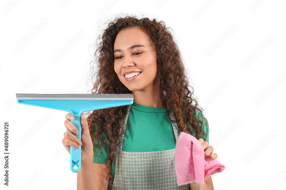 African-American female worker of cleaning service with squeegee and rag on white background African-American female worker of cleaning service with squeegee and rag on white background
