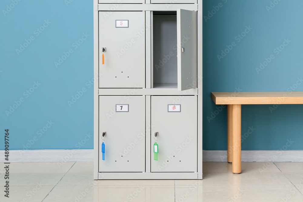 Modern locker and bench near blue wall Modern locker and bench near blue wall