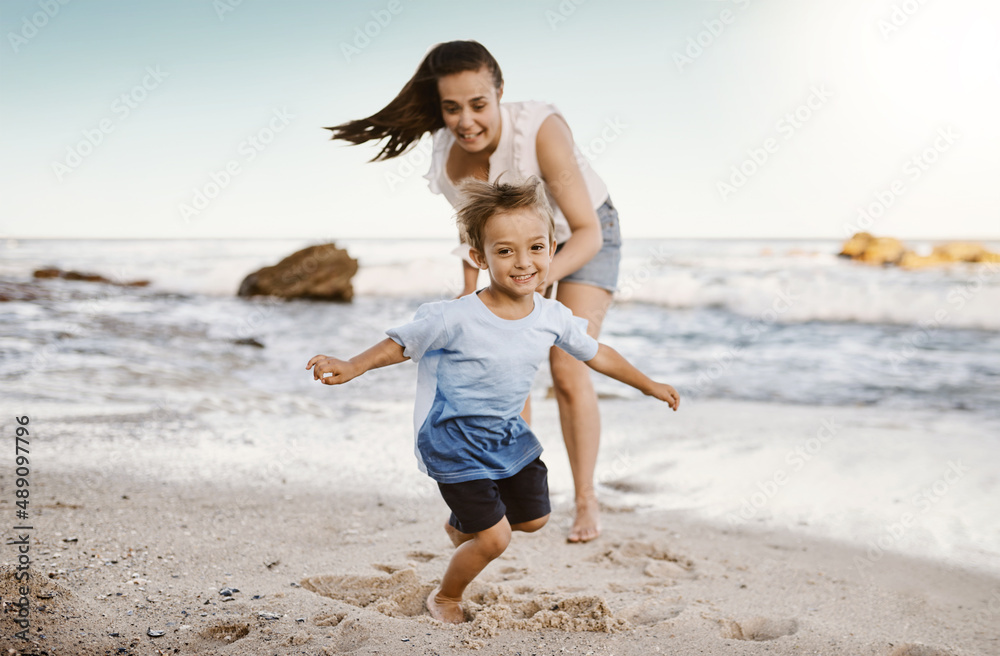 Its all fun and games at the beach. Shot of a mother bonding with her little son at the beach. Its all fun and games at the beach. Shot of a mother bonding with her little son at the beach.
