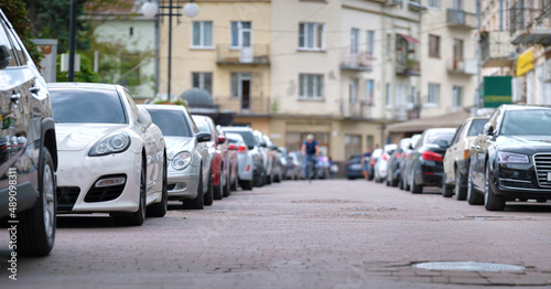 Cars parked in line on city street side. Urban traffic concept © bilanol
