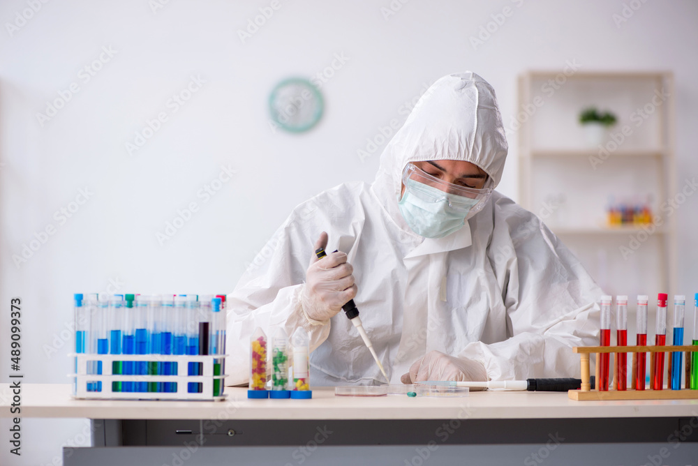 Young male chemist in drugs synthesis concept Young male chemist in drugs synthesis concept