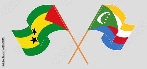 Crossed and waving flags of Sao Tome and Principe and Comoros