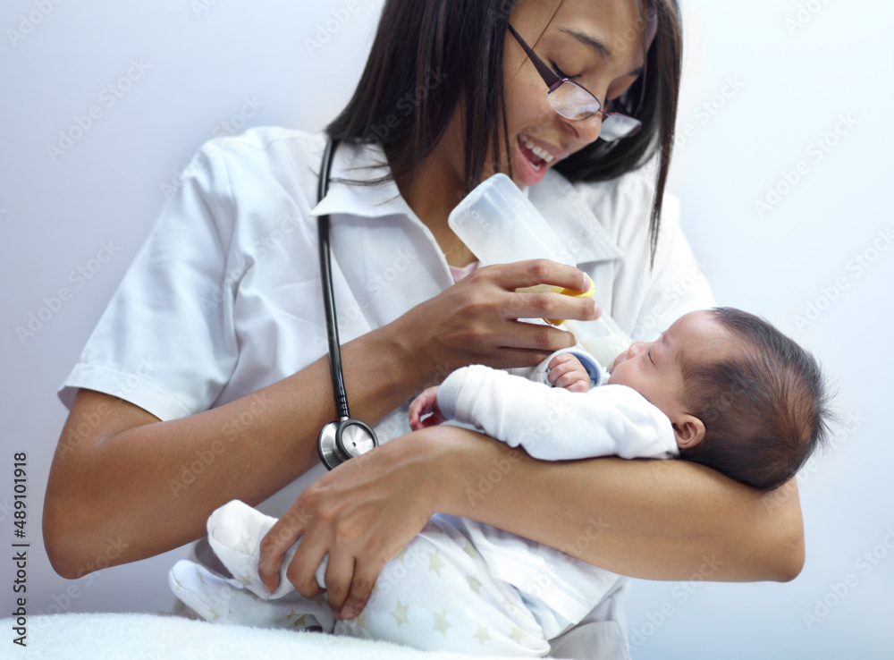 Making a caring contribution to society. Shot of a healthcare worker giving formula to an infant who has a cleft palate. Making a caring contribution to society. Shot of a healthcare worker giving formula to an infant who has a cleft palate.