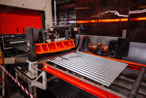 Modern roll forming machine in metal profiling workshop