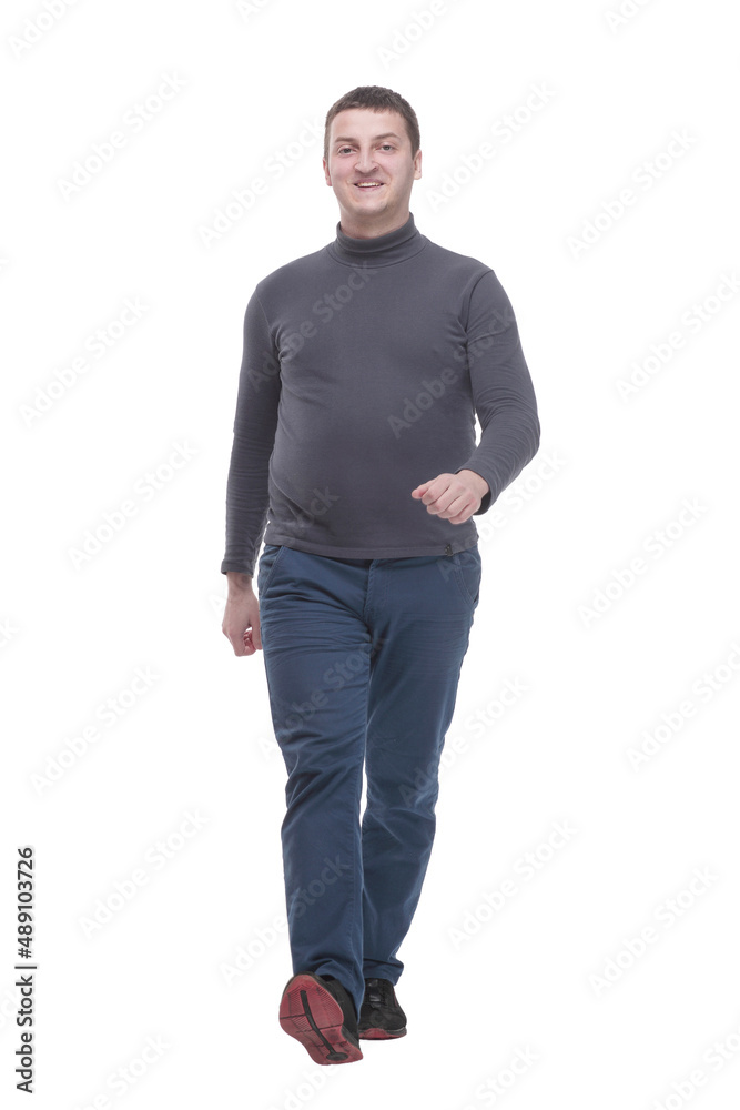 young man in casual clothing striding forward. young man in casual clothing striding forward.