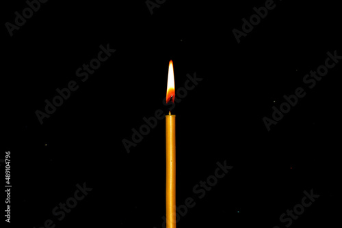 candle flame on a dark background, close-up as a texture for a background