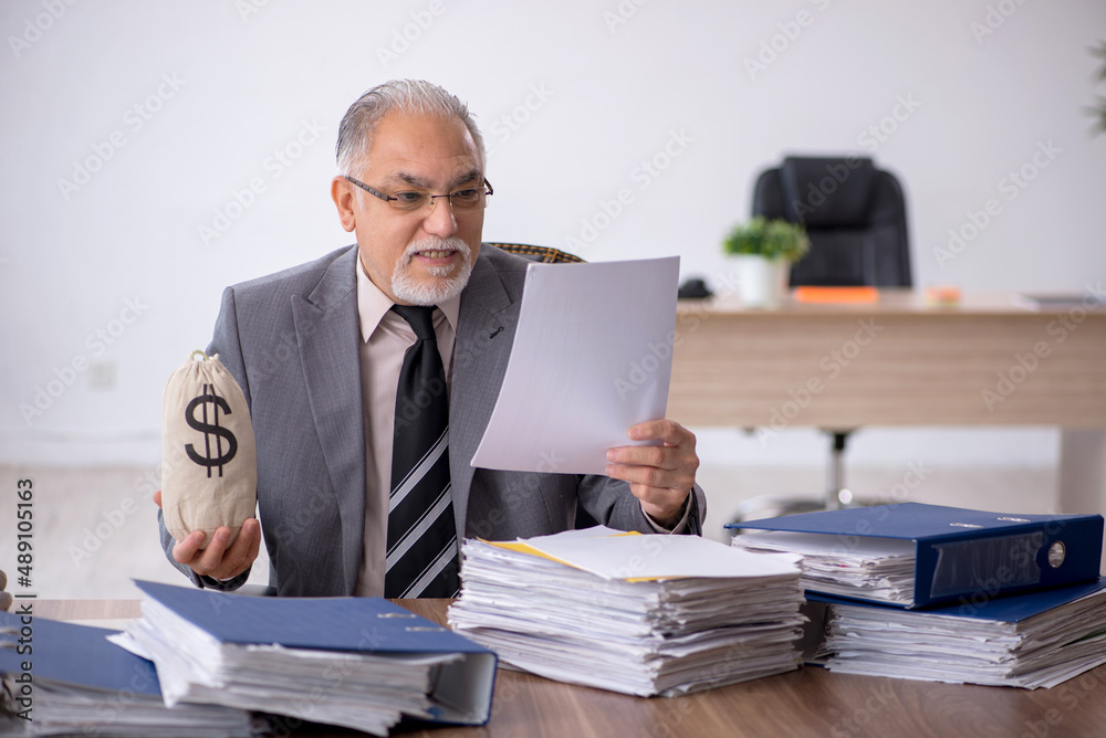 Old male employee in remuneration concept Old male employee in remuneration concept