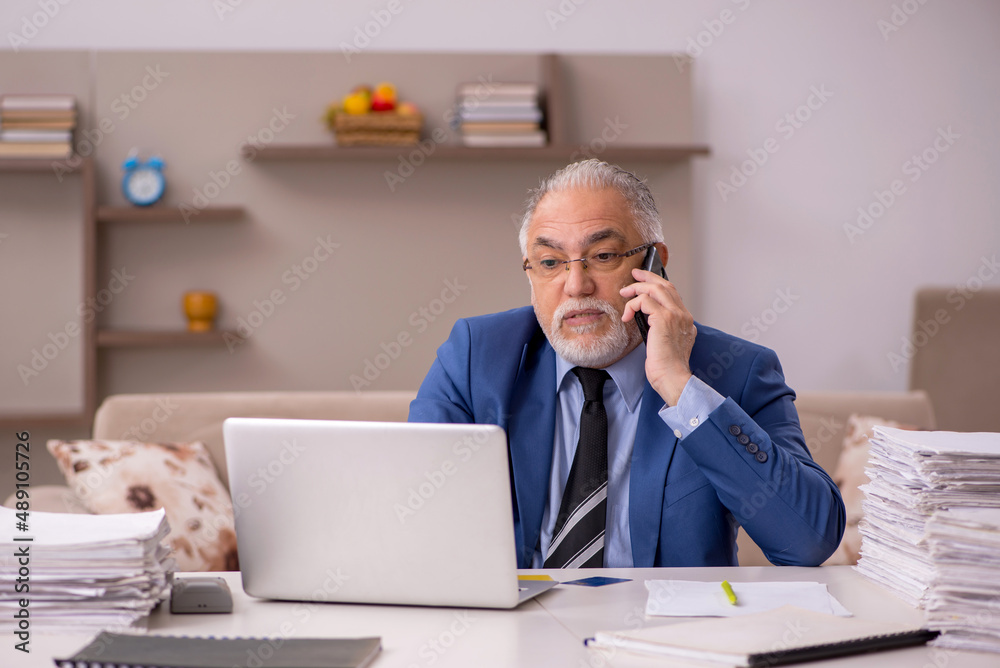 Old male boss working from home during pandemic Old male boss working from home during pandemic