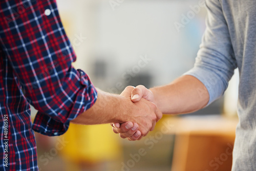 The start of a perfect partnership. Closeup shot of two men shaking hands in a casual office. © D Laflor/peopleimages.com