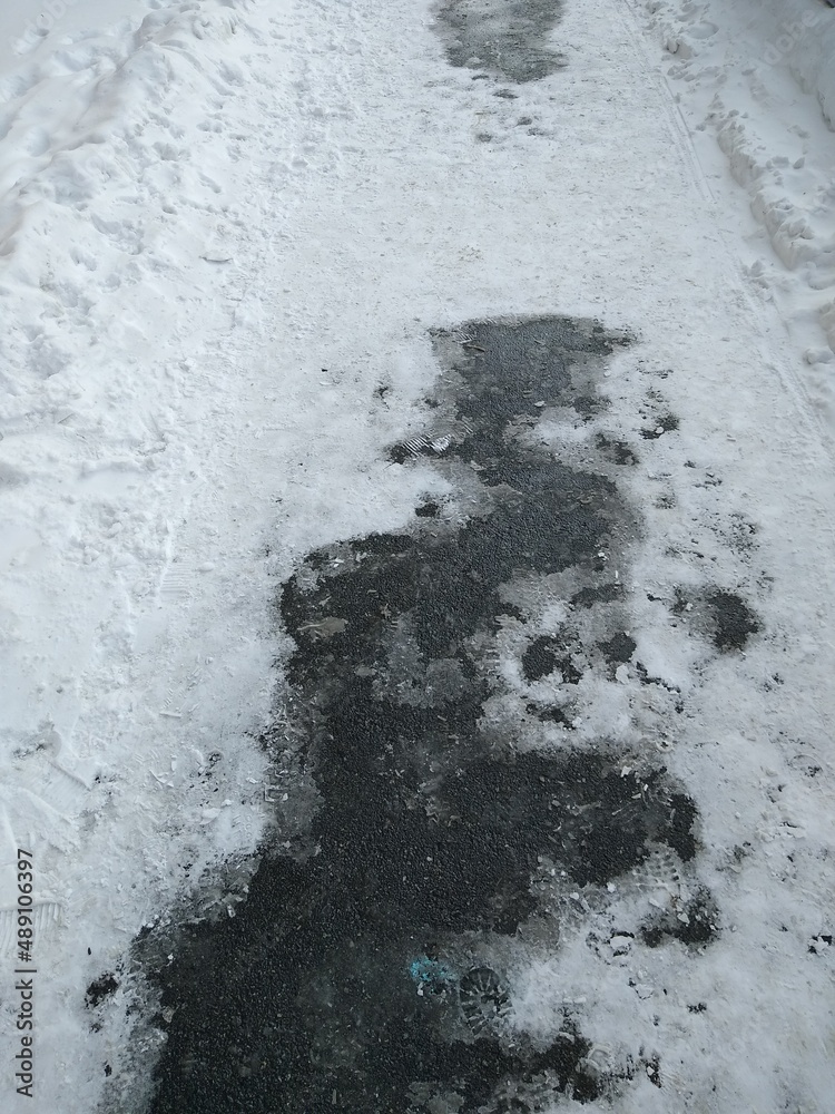 Asphalt path with melted snow close-up. High quality photo Asphalt path with melted snow close-up. High quality photo