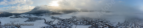 sunrise over village in the snow