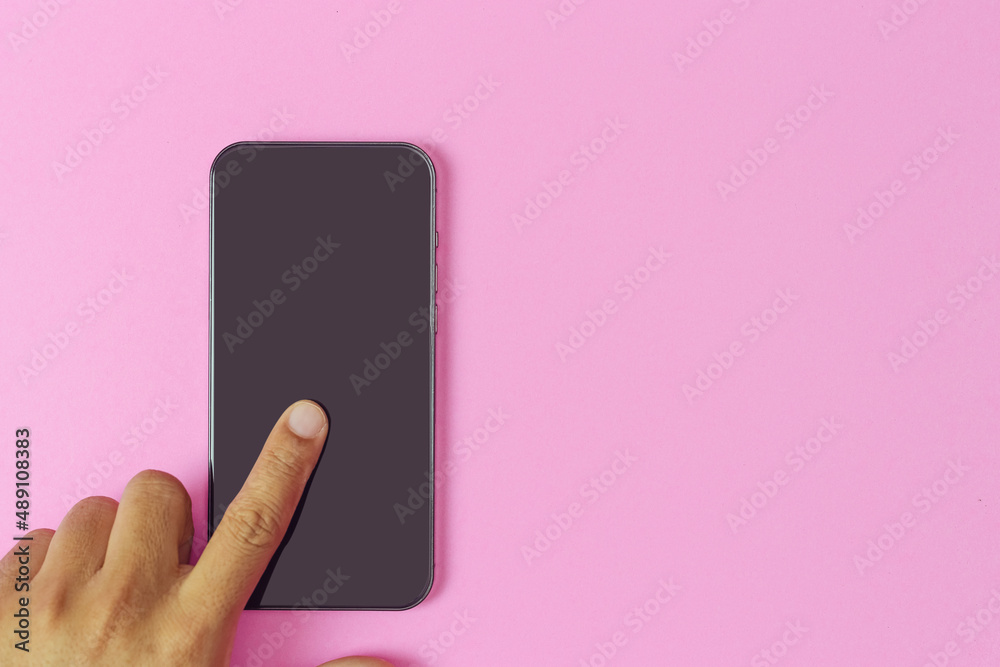 hand touch smartphone blank screen on pink background. hand touch smartphone blank screen on pink background.