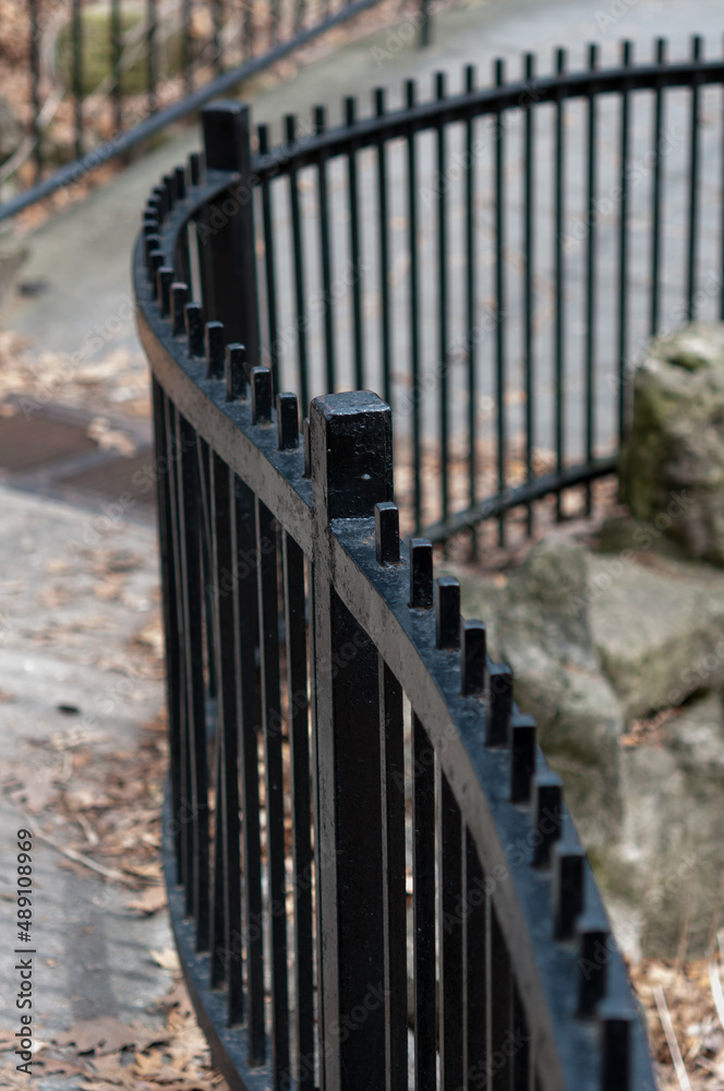 black iron fence in the park black iron fence in the park