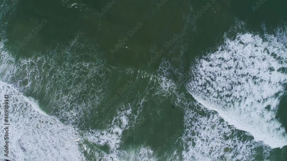 Aerial view big waves crashing against sand beach from above Beautiful sea surface at Phuket thailand beach is famous tourist destination
