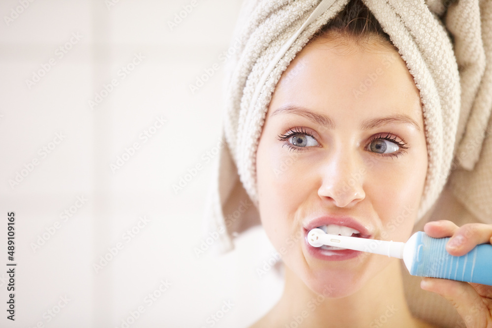 Keeping her teeth in great shape - Dental hygiene. Cropped shot of an attractive young woman brushing her teeth.