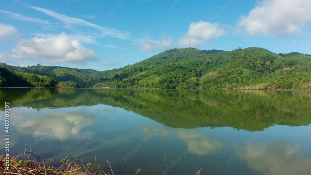 Beautiful reflection of clouds in water surface over lake or pond with Mountain tropical forest Time Lapse landscape nature footage Beautiful reflection of clouds in water surface over lake or pond with Mountain tropical forest Time Lapse landscape nature footage