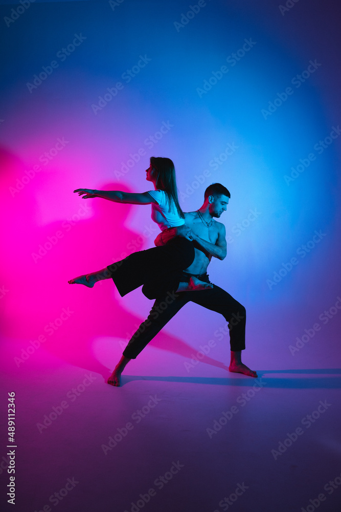 Gymnastics support. A man and a girl perform an acrobatic exercise
