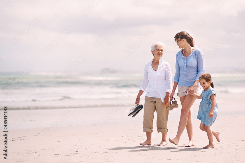 Enjoying a girls day out. Portrait of a woman with her daughter and mother at the beach.