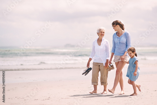 Enjoying a girls day out. Portrait of a woman with her daughter and mother at the beach.