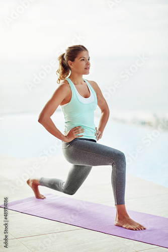 Shes all about fitness. Shot of a young woman doing lunges during a workout.