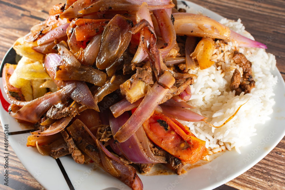 Lomo saltado with beef and Italian tripe with white rice, julienned onions, tomatoes and golden French fries Lomo saltado with beef and Italian tripe with white rice, julienned onions, tomatoes and golden French fries