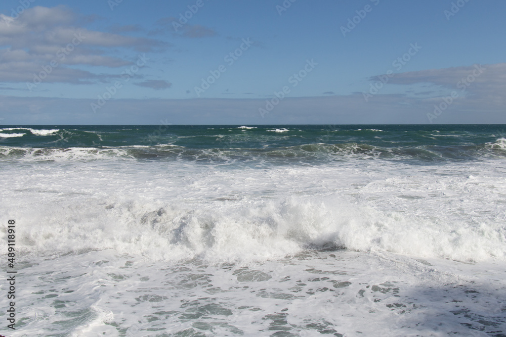 Marine Landscape with big waves, horizon line and blue sky.