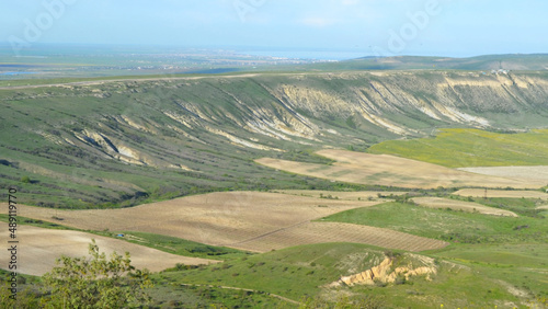 Scenic beauty, landscape scene, view of hills and green valleys with blue sky and sea on the horizon.