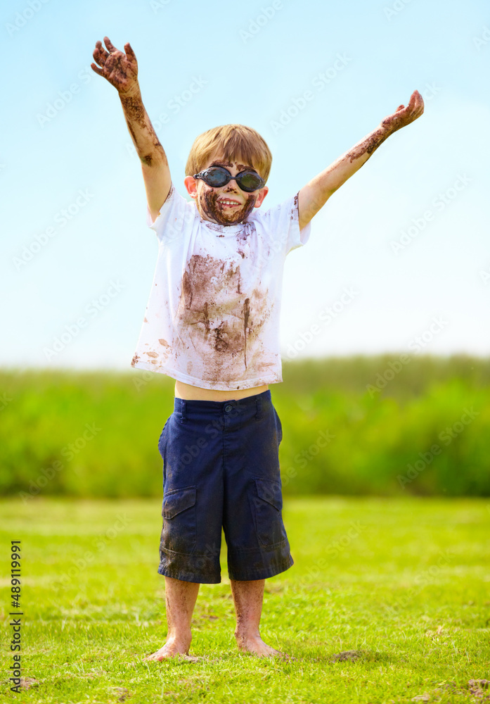 A muddy superhero. A little boy dressed as a superhero and covered in mud. A muddy superhero. A little boy dressed as a superhero and covered in mud.