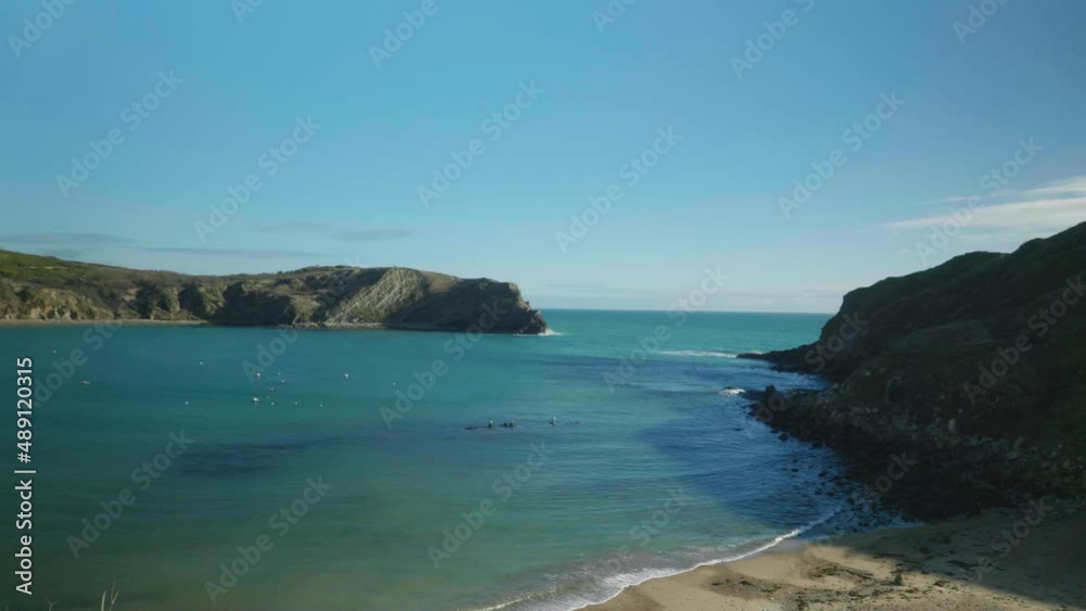 4K Cinematic landscape shot of the beach of Lulworth Cove, Dorset on a sunny day. 4K Cinematic landscape shot of the beach of Lulworth Cove, Dorset on a sunny day.