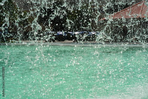 The gush of water of a fountain. Splash of water in the fountain in waterpark.
