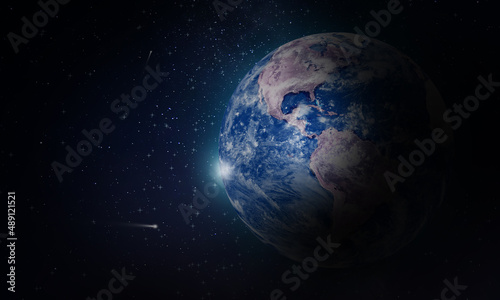 Planet earth in outer space with stars and universe particles background 