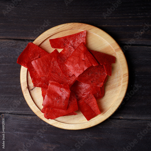 Beer with snacks on dark wooden table. Top view
